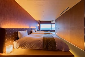 Modern hotel room featuring plush textiles and wooden elements