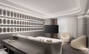A sleek, modern hotel room featuring metallic finishes and a minimalist design.