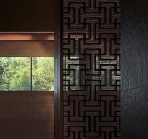 Close-up of a modern interior wall featuring a metallic geometric pattern.
