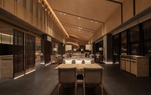 Modern restaurant interior with concrete, metal, and glass materials.
