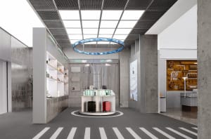 Modern retail storefront with concrete walls, metal accents, and glass display cases.