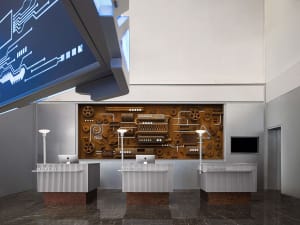 A modern lobby with metal walls and white reception desks.