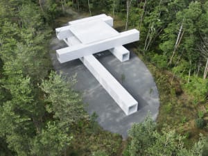 A modern architectural pavilion constructed from concrete.
