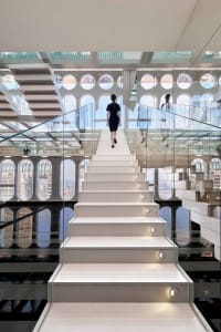 A modern interior space featuring white glass walls and sustainable design elements.