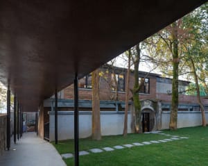 Modern exterior of a building featuring brick and concrete materials.