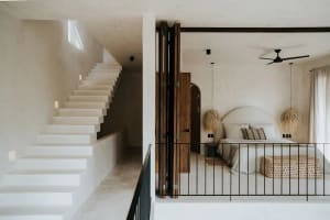 A modern bedroom featuring concrete elements and a minimalist design.