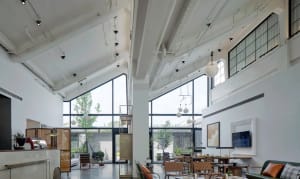Modern lobby featuring glass, concrete, and metal elements.