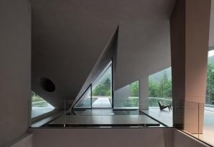 A modern office space featuring metal frame and glass walls.