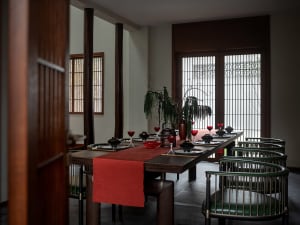 A modern dining room with wooden furniture and glassware.