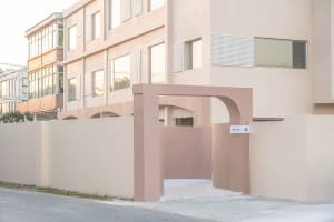 Modern building exterior with minimalist design and neutral concrete color