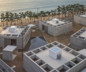 A modern, concrete residence overlooking the beach with a minimalist design.