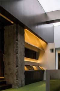 A modern industrial space featuring concrete walls and steel elements.