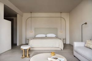 A minimalist bedroom with neutral tones and a cozy, modern feel.