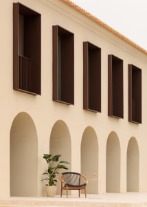 Modern building facade with arches, minimalist design, sandstone material