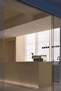 Modern minimalist coffee shop counter featuring transparent glass