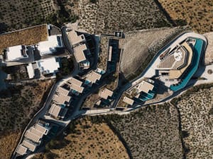 Aerial view of a modern resort with concrete and glass structures.
