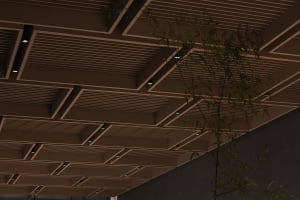 Industrial-style ceiling design featuring wooden panels and metallic accents.