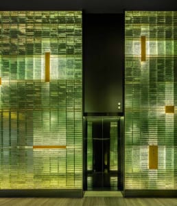 A minimalist design featuring a modern hotel doorway with a glass panel