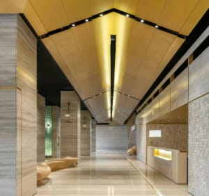 Interior view of a modern minimalist lobby featuring concrete walls and flooring.