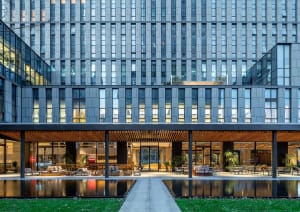 A modern office building with glass and concrete materials.