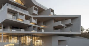 Modern residential building with concrete structure and balconies.
