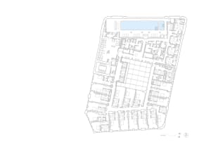 A detailed blueprint of an office space layout on a paper sheet, showing various rooms and their arrangement.