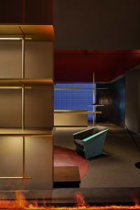 A modern hotel reception with metallic shelving and a sleek, minimalist design.