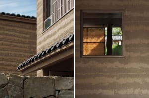 An architectural exterior featuring sandstone walls and tiled roof.