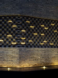 A modern wall design featuring brick and lighting elements.