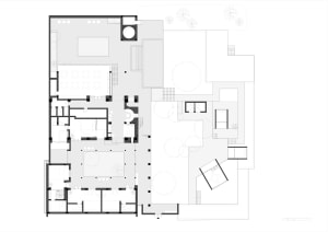 Floor plan of a modern office space depicted in white lines and shapes.