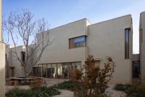 A modern building with concrete and brick exteriors.