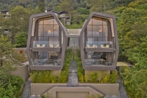 Modern residential house with concrete facade and large glass windows
