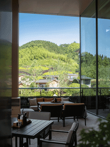 Outdoor seating area with wooden furniture and mountain view