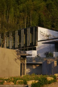 Modern residential house with glass walls and concrete exterior