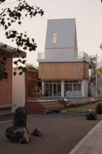 Modern residential house with wooden and metallic exterior.