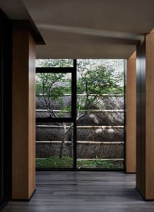 A view through a wooden window in an industrial-style room.