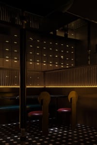 A modern industrial restaurant interior with wooden furniture and lighting.