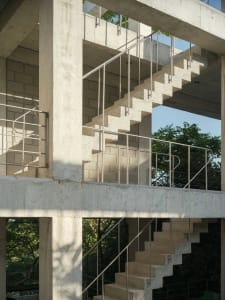 Concrete stairs with metal railings in a modern architectural setting.