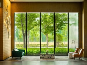 Modern interior design featuring a concrete fireplace and wood flooring in a living room setting.