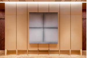 A minimalist interior design with a metallic canvas wall.