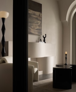 A modern minimalist living room with neutral tones, elegant furniture, and decorative elements.