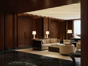 A modern living room featuring wood, marble, leather, and fabric elements.