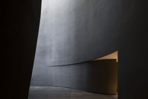 A modern lobby interior with concrete walls and floor.