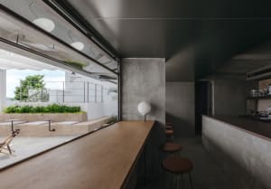 Modern interior design featuring a concrete and wood bar counter with minimalistic aesthetics.