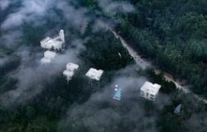 Modern residential buildings surrounded by clouds with concrete and glass materials