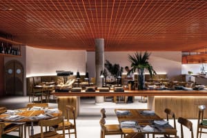 Industrial-themed restaurant interior featuring wooden furniture and materials.