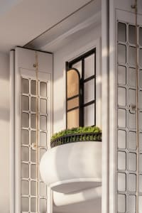 A modern residential interior featuring a glass window with greenery.