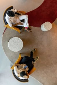 Modern lounge area with concrete poufs and minimalist seating.