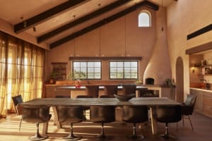 A modern residential interior featuring a combination of concrete, wood, and leather materials.
