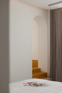 A minimalist interior with concrete walls and wooden elements.